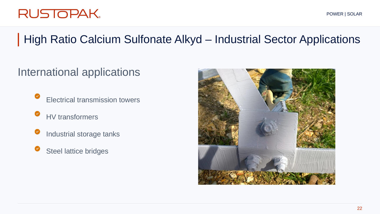 Slide 22: Industrial application list beside a photograph of a grey-coated bolted steel joint.