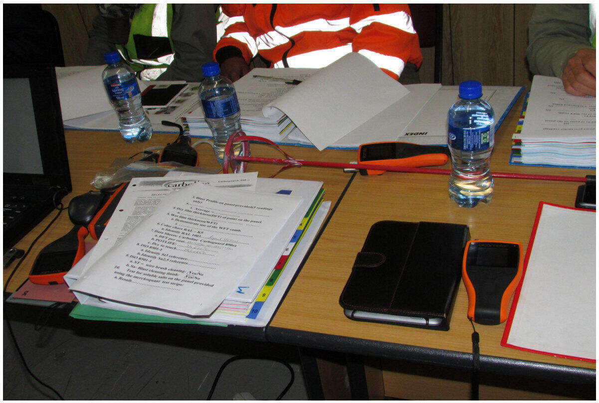 Training table with course documents, inspection equipment and coating materials