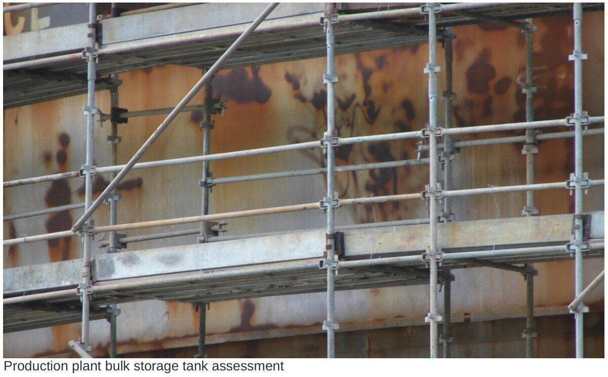 Bulk storage tank surface viewed behind scaffolding during a condition assessment